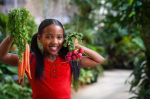 Girl holding produce